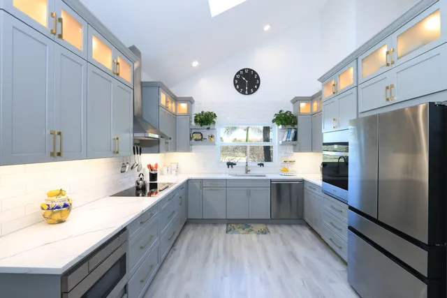 a spacious bedroom with a bed and a chandelier