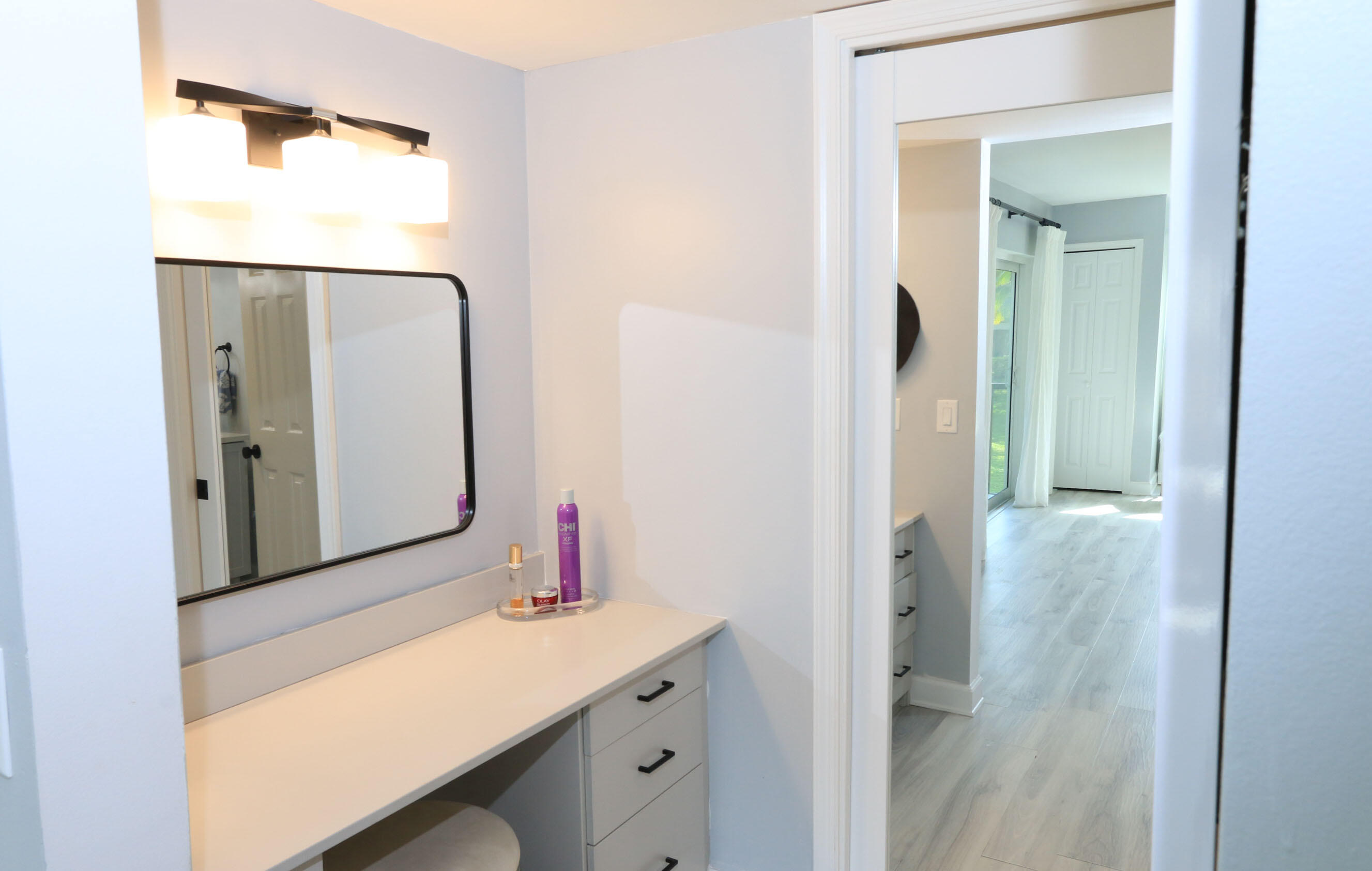 4161 U.S. Highway 1, Unit E3 Jupiter, FL 33477 - Photo 36 of 86 a bathroom with a sink and mirror