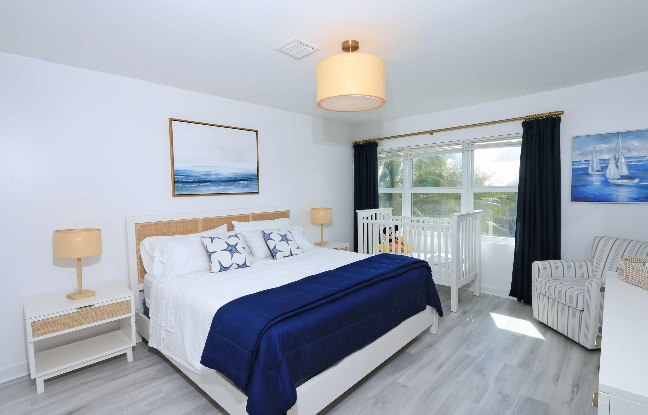 4161 U.S. Highway 1, Unit E3 Jupiter, FL 33477 - Photo 47 of 86 a bedroom with a bed and a painting on the wall