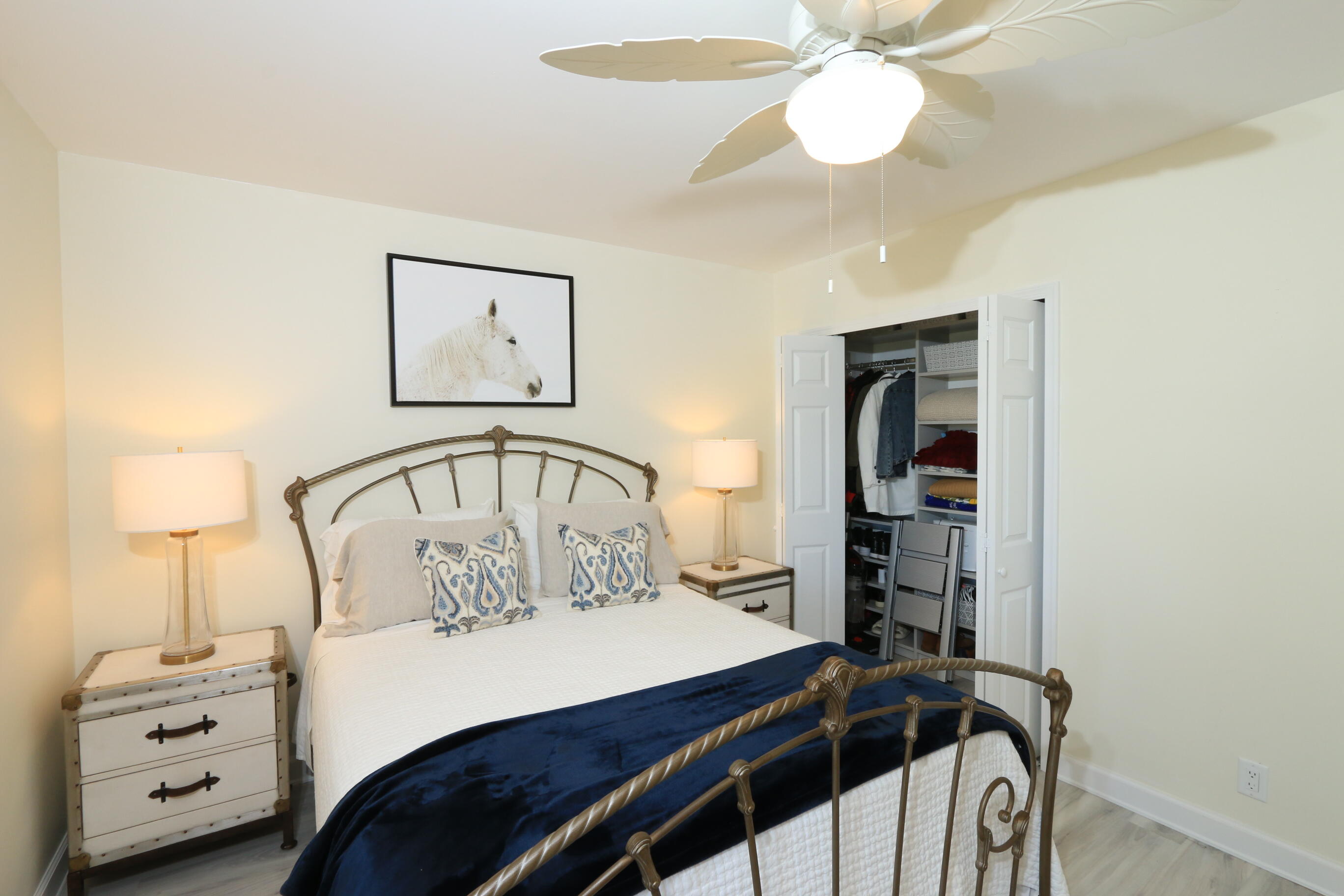 4161 U.S. Highway 1, Unit E3 Jupiter, FL 33477 - Photo 54 of 86 a bedroom with a bed and a chandelier