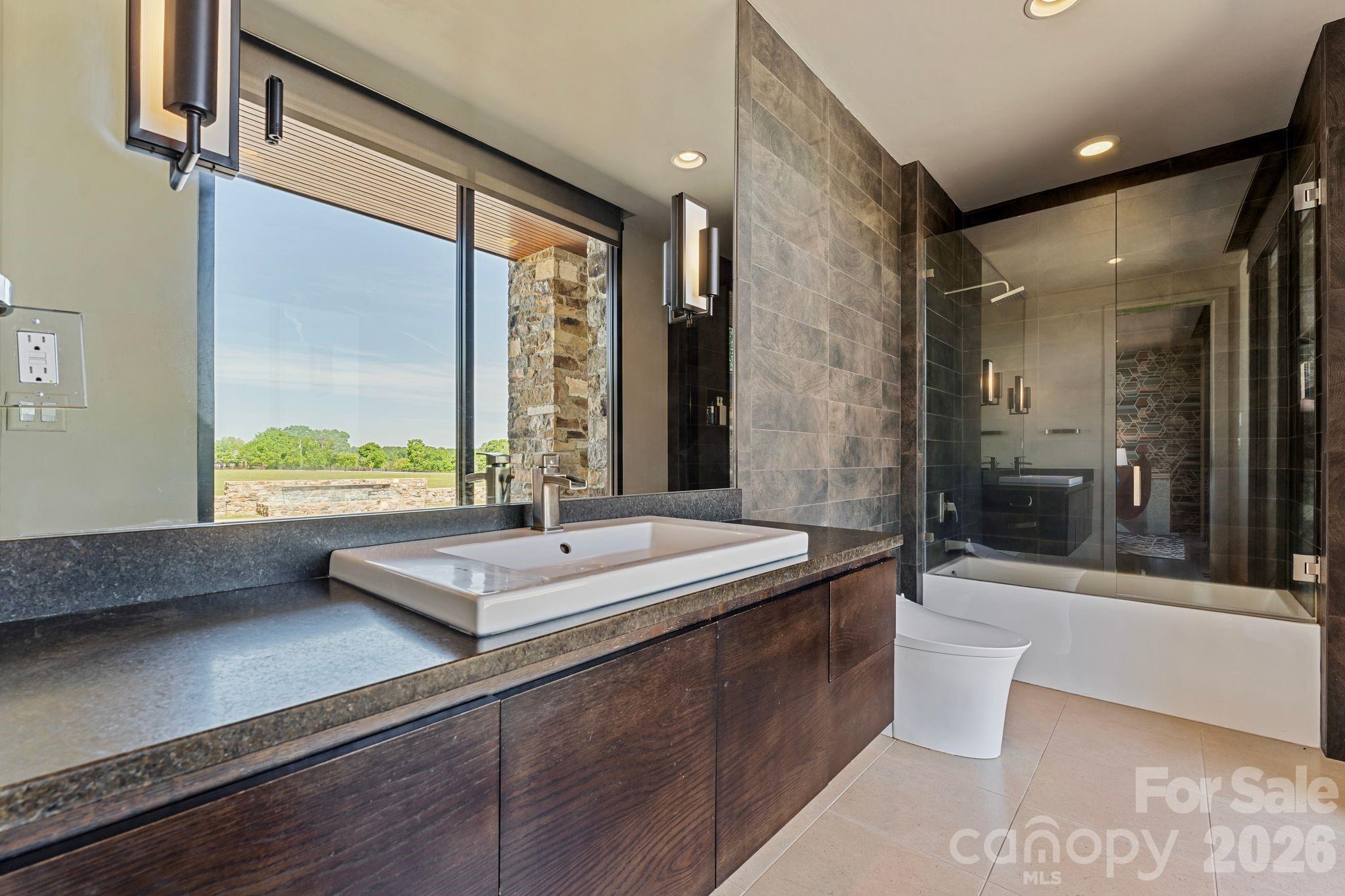 1795 Faires Road Rock Hill, SC 29730 - Photo 31 of 48 a bathroom with a granite countertop sink a large mirror and a bathtub