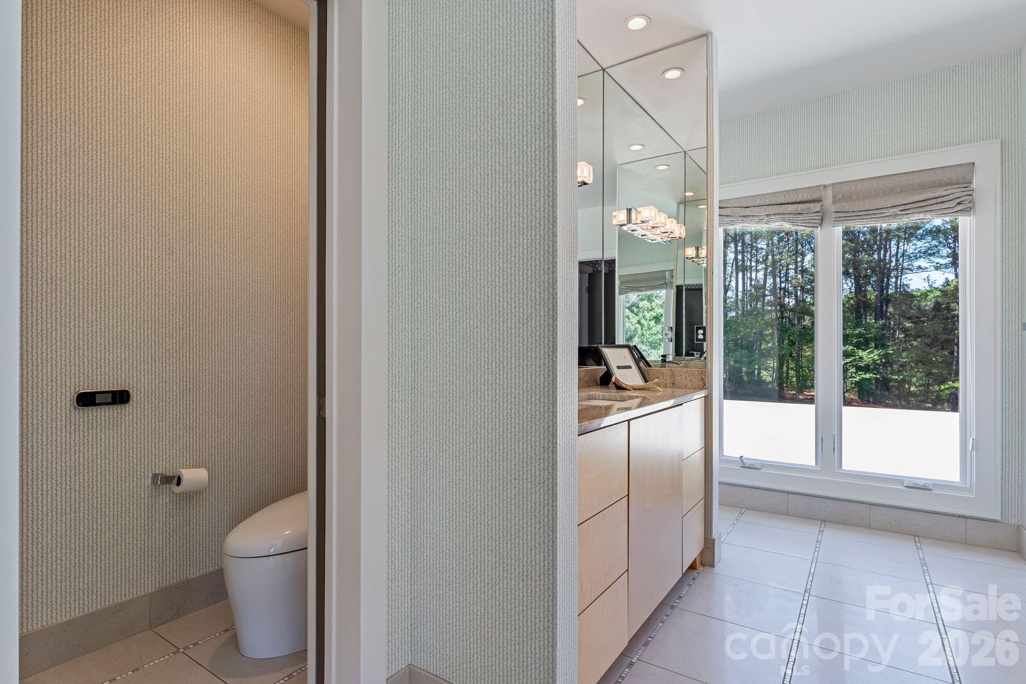 1795 Faires Road Rock Hill, SC 29730 - Photo 37 of 48 a bathroom with a granite countertop toilet a sink and a large mirror