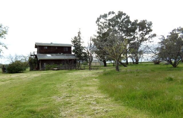 19009 Paskenta Road Corning, CA 96021 - Photo 1 of 33 a backyard of a house with lots of green space