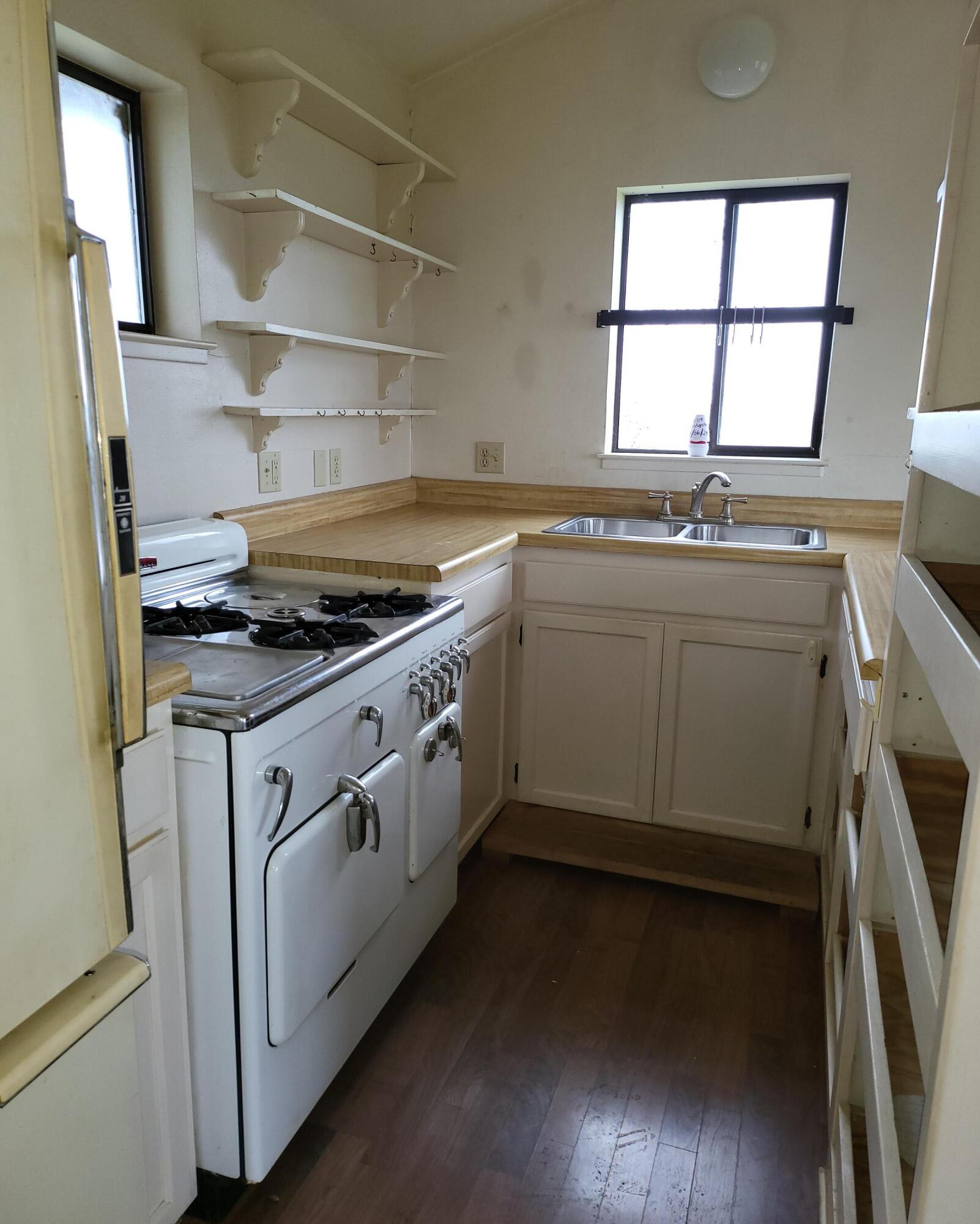 19009 Paskenta Road Corning, CA 96021 - Photo 11 of 33 a kitchen with a stove and white cabinets