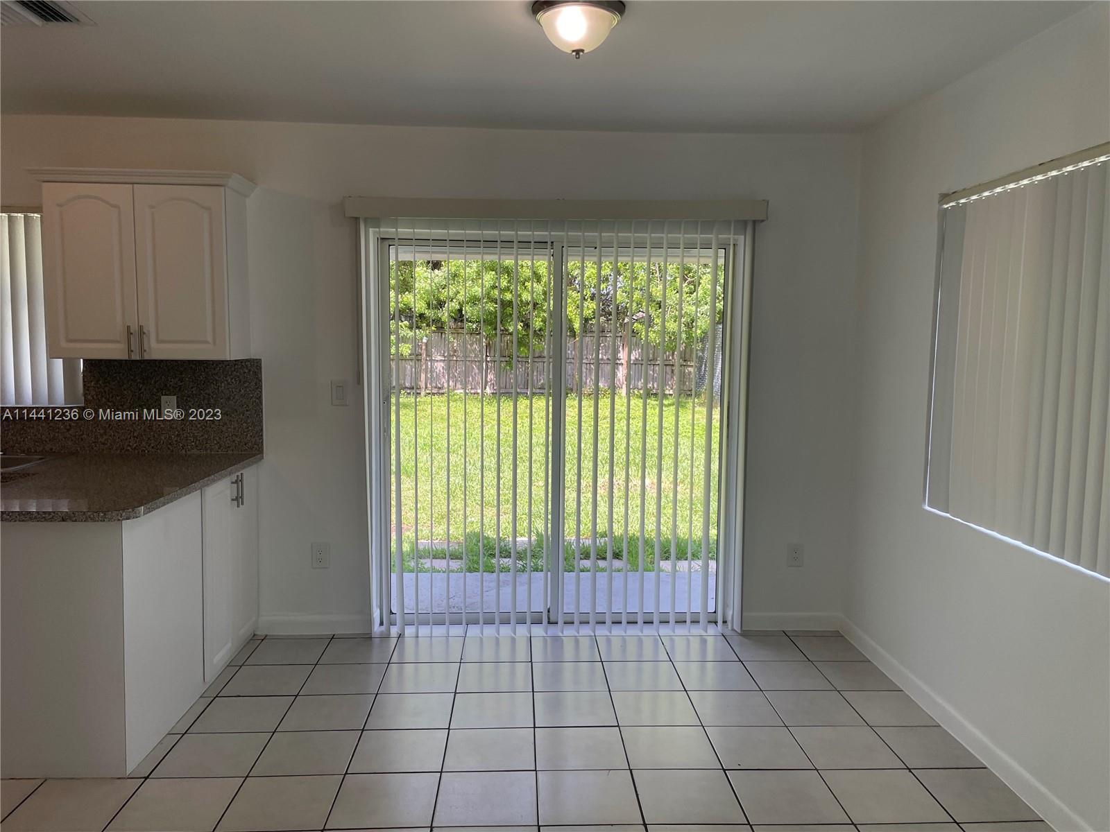 20048 Southwest 87th Place Cutler Bay, FL 33189 - Photo 4 of 11 a view of an empty room with a window