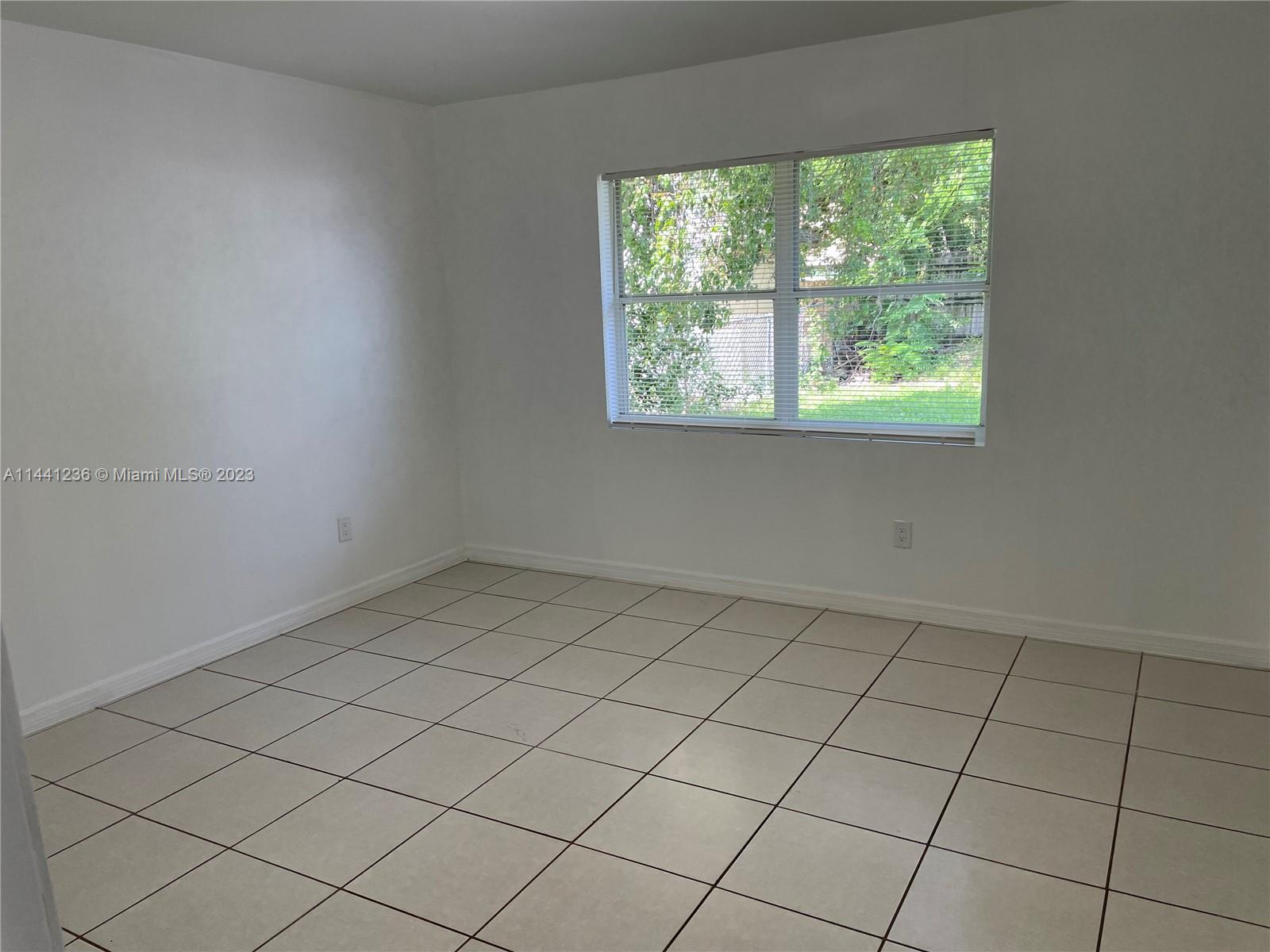20048 Southwest 87th Place Cutler Bay, FL 33189 - Photo 6 of 11 an empty room with a window