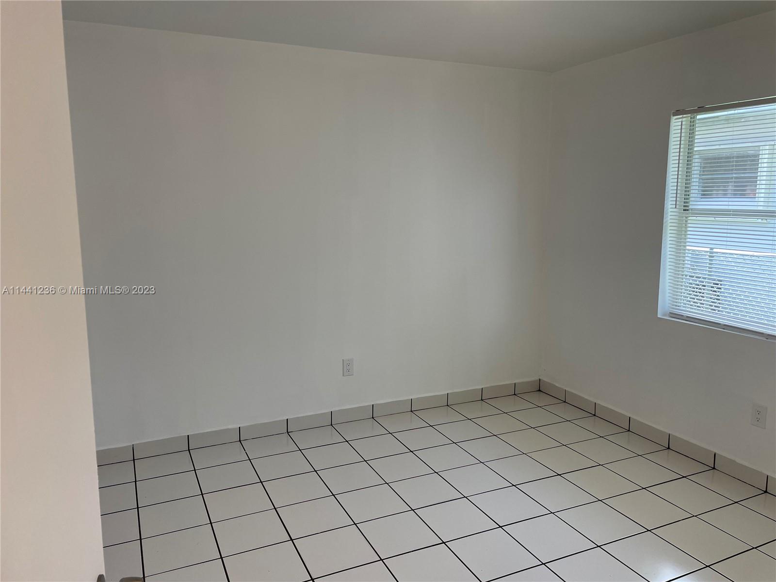 20048 Southwest 87th Place Cutler Bay, FL 33189 - Photo 8 of 11 a view of an empty room and window