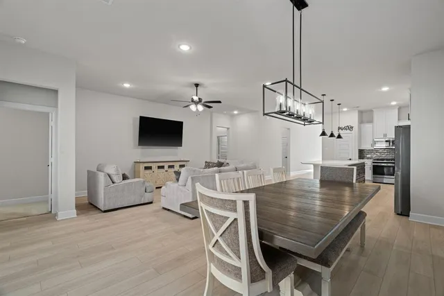 a dining room with furniture and wooden floor