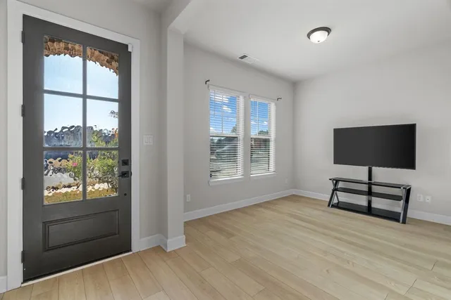 wooden floor cabinet and windows in a room