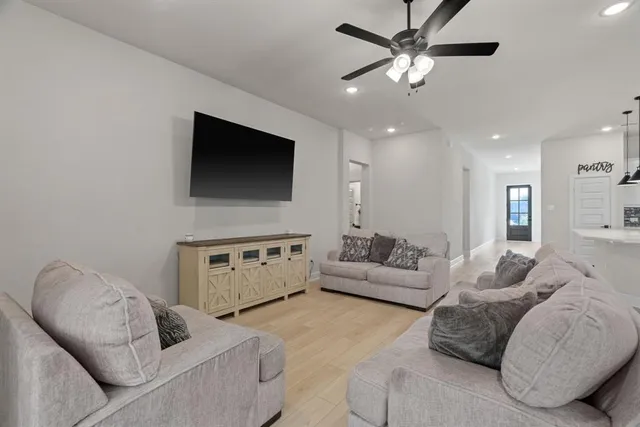 a living room with furniture and a flat screen tv
