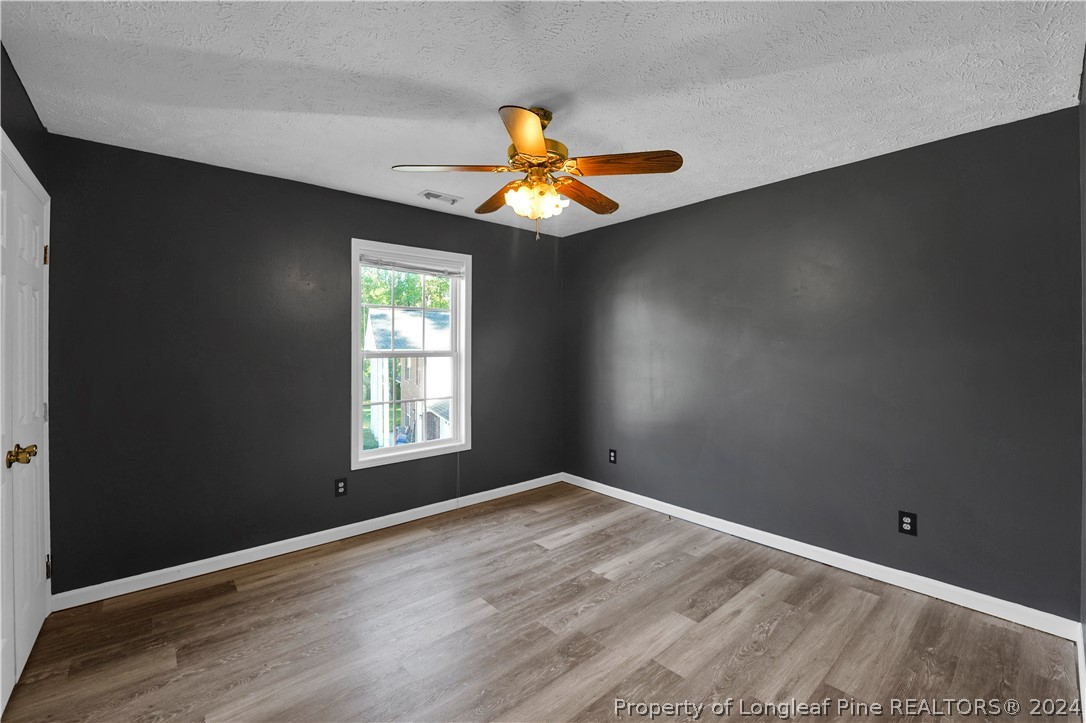 229 Lakeside Road Raeford, NC 28376 - Photo 13 of 17 wooden floor in an empty room with a window