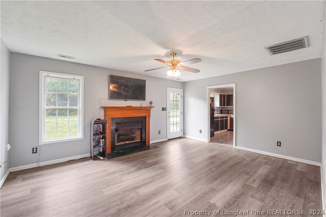 229 Lakeside Road Raeford, NC 28376 - Photo 3 of 17 an empty room with furniture and a fireplace
