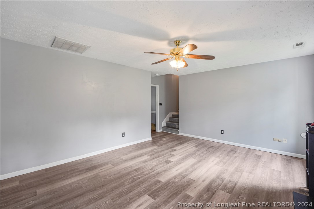 229 Lakeside Road Raeford, NC 28376 - Photo 4 of 17 an empty room with wooden floor and window