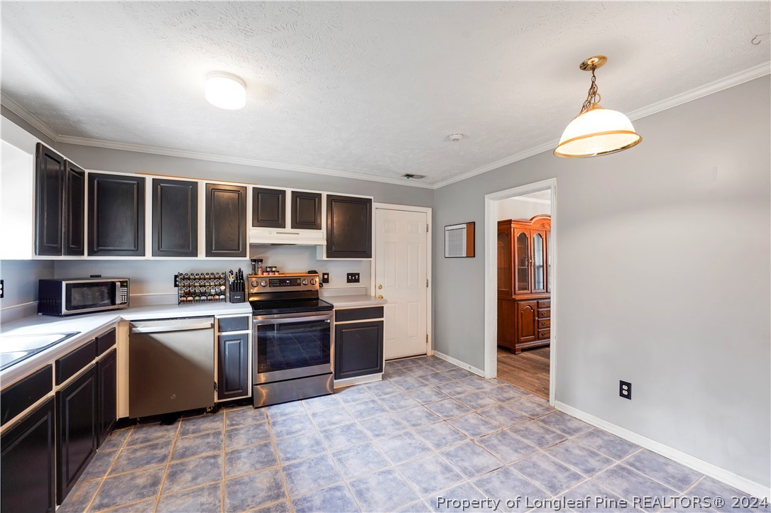 229 Lakeside Road Raeford, NC 28376 - Photo 6 of 17 a kitchen with stainless steel appliances granite countertop a stove and a sink
