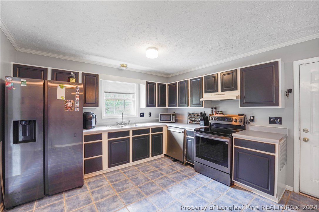 229 Lakeside Road Raeford, NC 28376 - Photo 7 of 17 a kitchen with stainless steel appliances granite countertop a stove sink and refrigerator