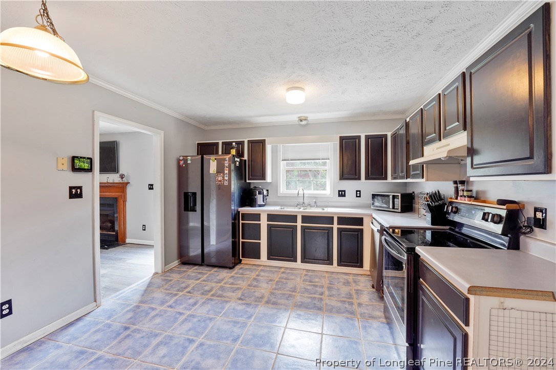 229 Lakeside Road Raeford, NC 28376 - Photo 8 of 17 a kitchen with stainless steel appliances granite countertop a refrigerator and a stove top oven