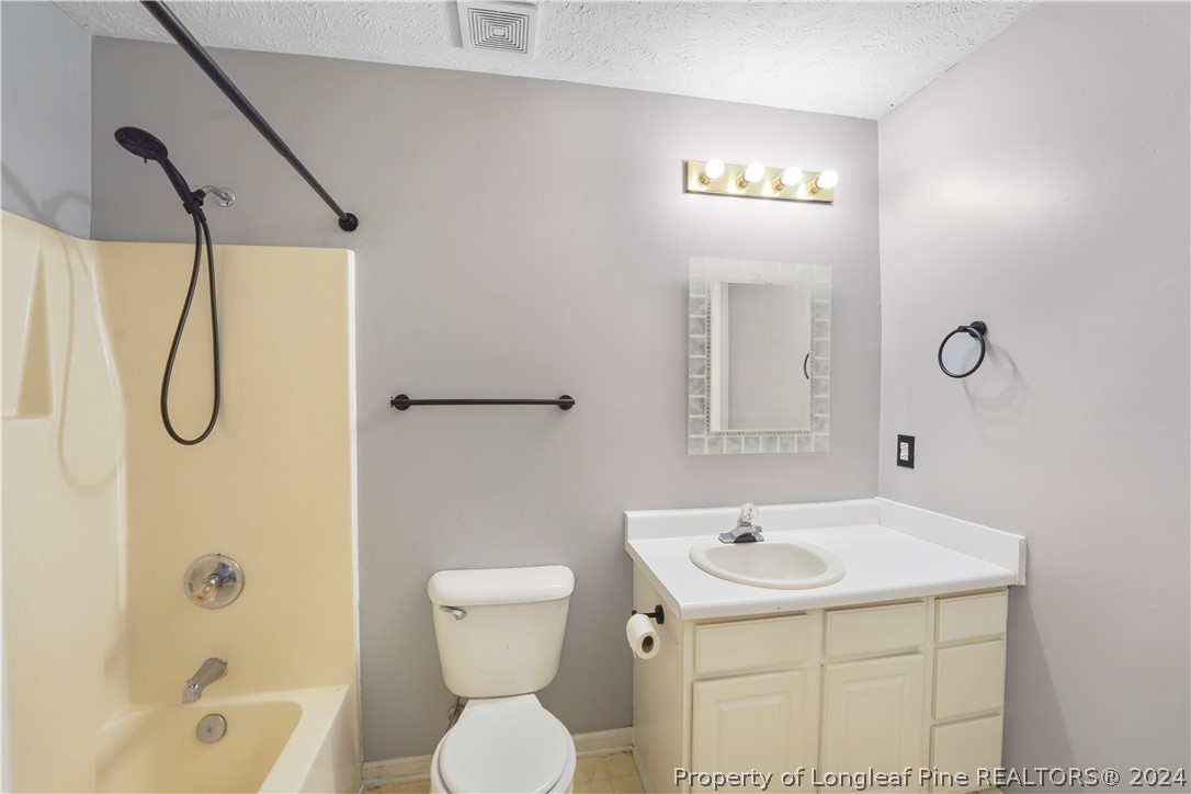 229 Lakeside Road Raeford, NC 28376 - Photo 9 of 17 a bathroom with a sink a toilet and shower