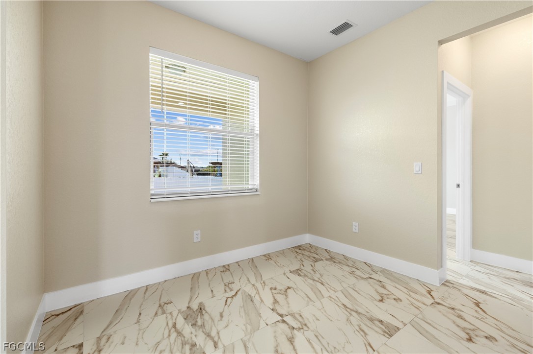 2919 23rd Street Southwest Lehigh Acres, FL 33976 - Photo 11 of 17 a view of a room with wooden floor and a window