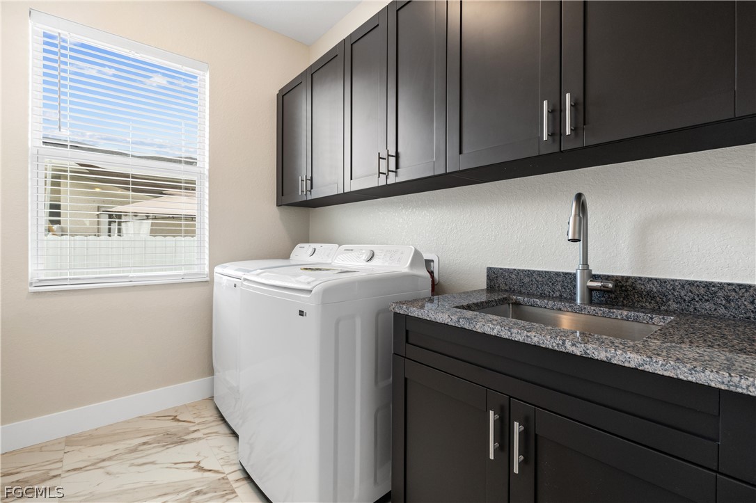 2919 23rd Street Southwest Lehigh Acres, FL 33976 - Photo 15 of 17 a utility room with granite countertop cabinets washer and dryer