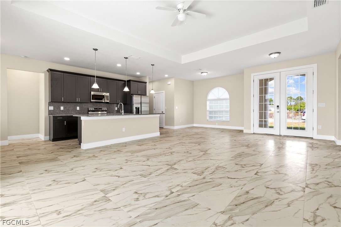 2919 23rd Street Southwest Lehigh Acres, FL 33976 - Photo 4 of 17 a view of a kitchen with a sink and a stove top oven