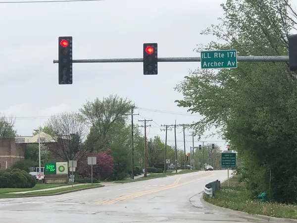 a street sign on a sidewalk next to a road