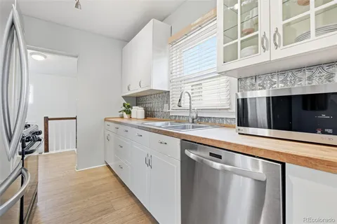 a kitchen with stainless steel appliances a stove and cabinets