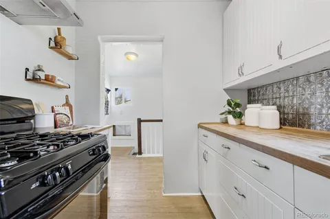 a kitchen with appliances a sink and cabinets