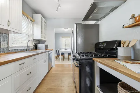 a kitchen with cabinets a sink and a potted plant
