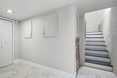 a bedroom with bed and a night stand