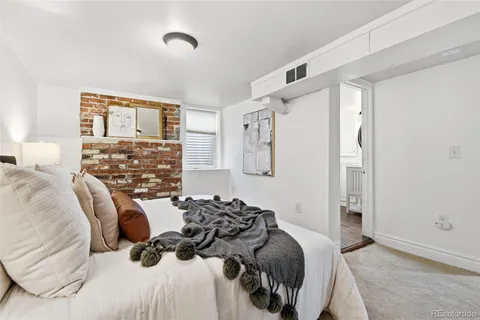 a bedroom with a bed and a night stand