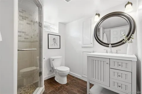 a white toilet sitting next to a shower