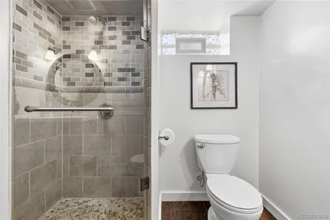 a bathroom with a toilet a sink and a mirror