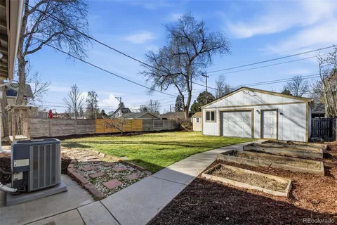 a backyard of a house with barbeque oven and outdoor seating