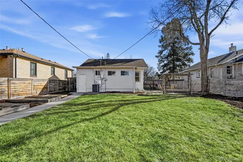 a front view of house with a garden
