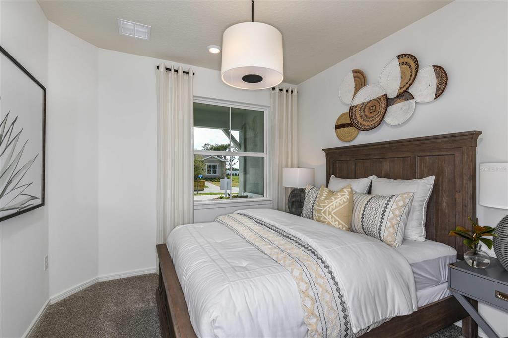 6318 Dew Drop Loop St. Cloud, FL 34771 - Photo 18 of 31 a bedroom with a bed and a window