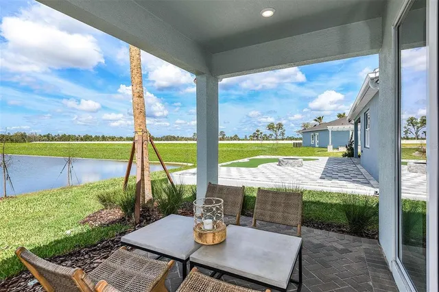 a view of an outdoor dining space with a table and chairs