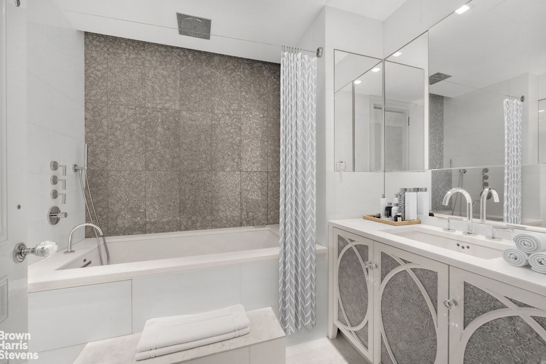 200 East 69th Street, Unit 47 Manhattan, NY 10021 - Photo 25 of 30 a bathroom with a bathtub a sink a toilet and a mirror