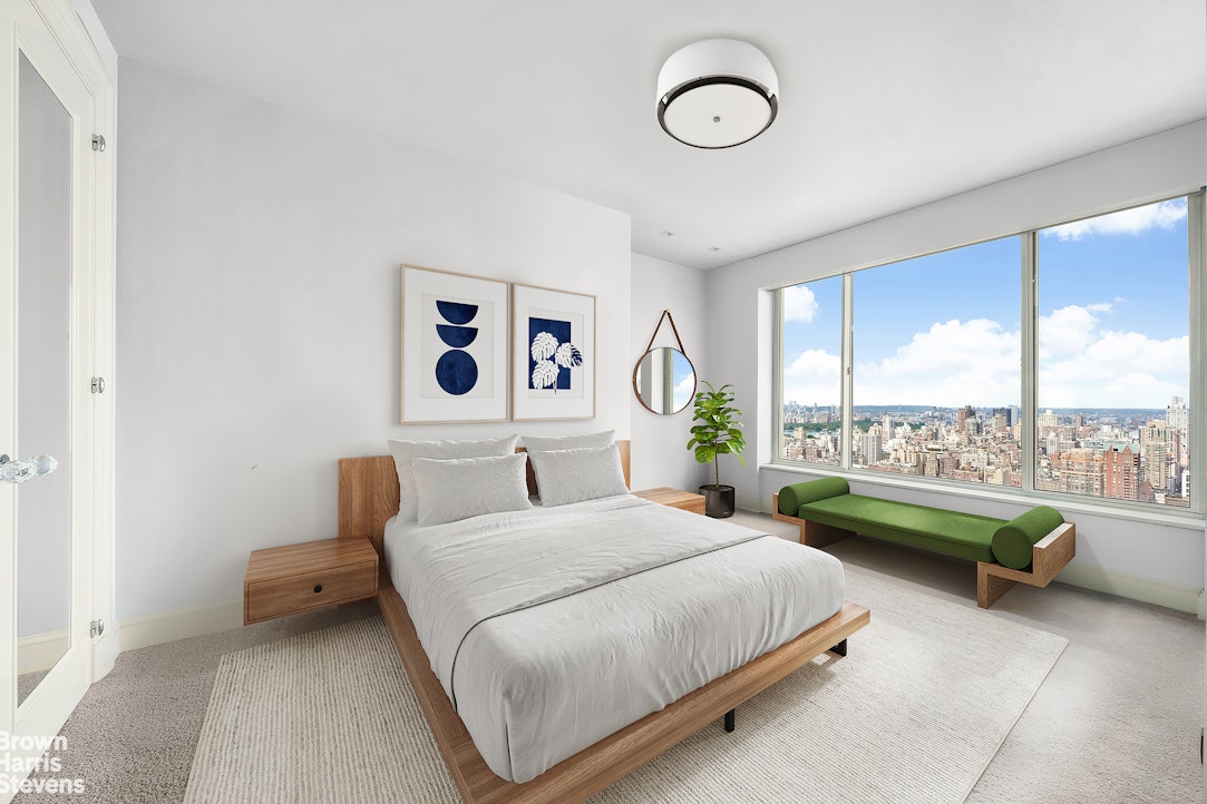 200 East 69th Street, Unit 47 Manhattan, NY 10021 - Photo 26 of 30 a bedroom with a bed and a large window