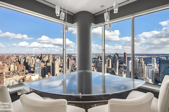 a very nice looking living room with a large window and a dining table with garden view