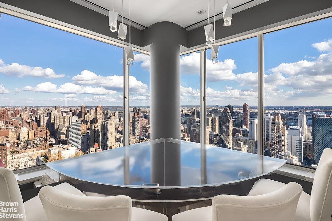 200 East 69th Street, Unit 47 Manhattan, NY 10021 - Photo 9 of 30 a view of a living room with furniture and floor to ceiling windows