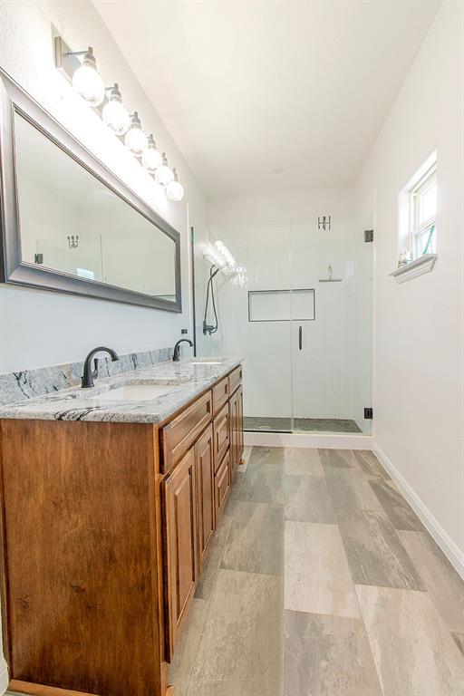 280 Lanier Road Combine, TX 75159 - Photo 11 of 36 a spacious bathroom with a granite countertop sink and a mirror