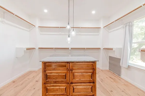 a kitchen with stainless steel appliances a table chairs and a refrigerator
