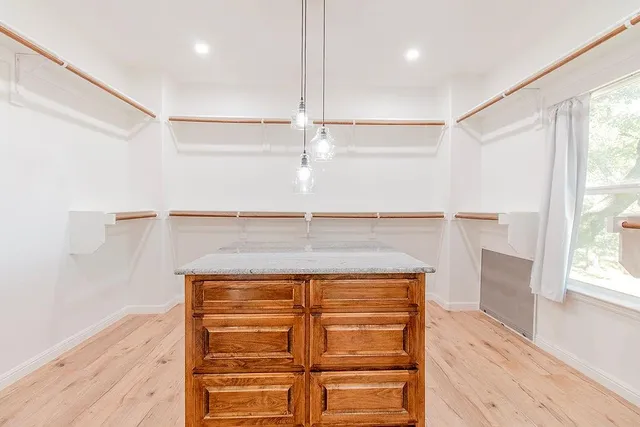 a kitchen with stainless steel appliances a table chairs and a refrigerator