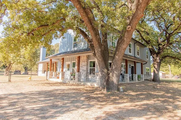 a front view of a house with a trees