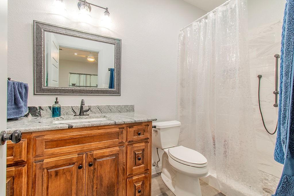 280 Lanier Road Combine, TX 75159 - Photo 22 of 36 a bathroom with a granite countertop toilet sink and mirror