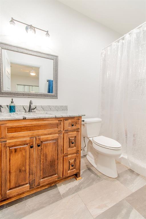 280 Lanier Road Combine, TX 75159 - Photo 23 of 36 a bathroom with a granite countertop toilet sink and mirror