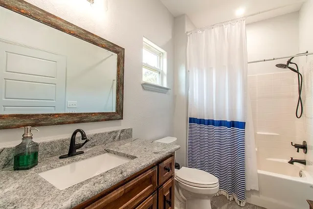 a view of a room with wooden floor and potted plant
