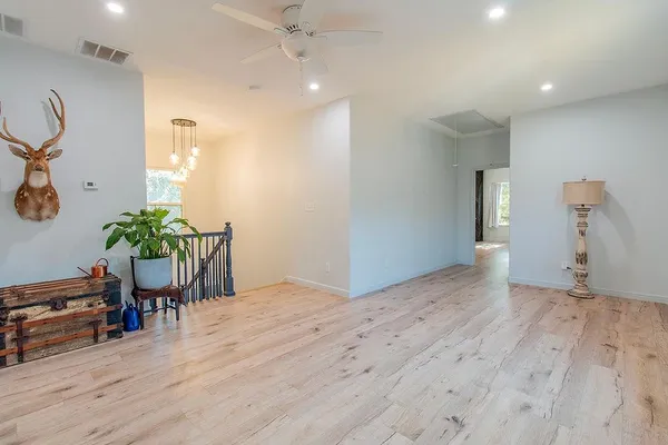 a view of a livingroom with wooden floor and window