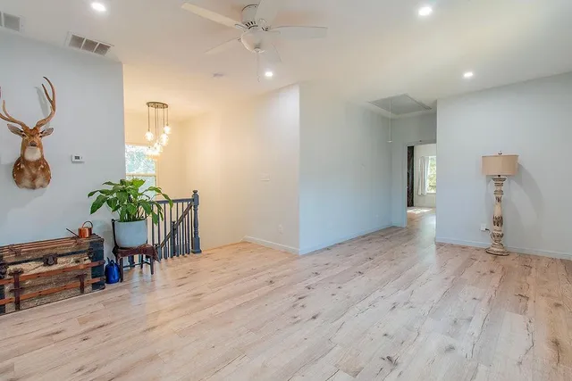 a view of a livingroom with wooden floor and window