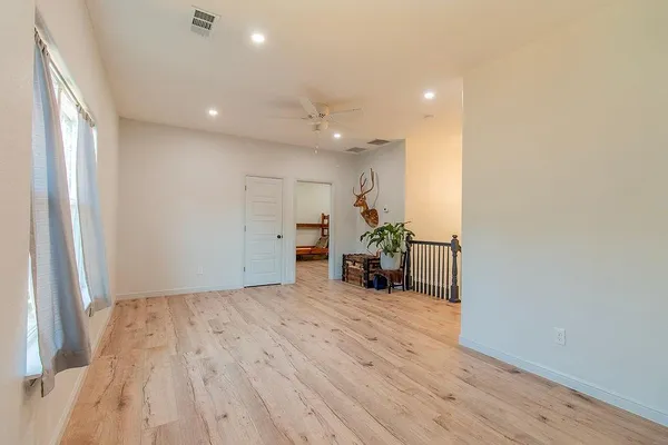 a bathroom with a granite countertop sink a mirror and a toilet